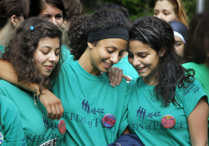Zeena, left, Yomna and Nour listen during the Seeds of Peace opening ceremony. All three are with the Egyptian delegation, and Yomna and Nour are first-time campers.