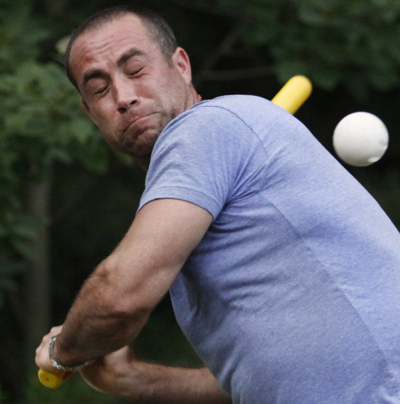 Nathan Metivier of Falmouth grimaces as he is hit with a pitch during a practice for the South Street Hard Shells Wiffle Ball team.