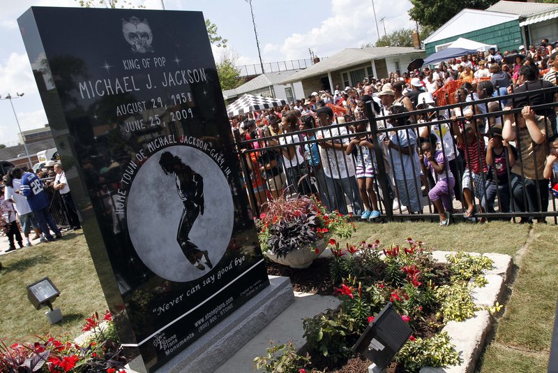 Michael Jackson fans gather around a monument that was unveiled Friday in the singer’s hometown of Gary, Ind., on the first anniversary of the pop icon’s death.