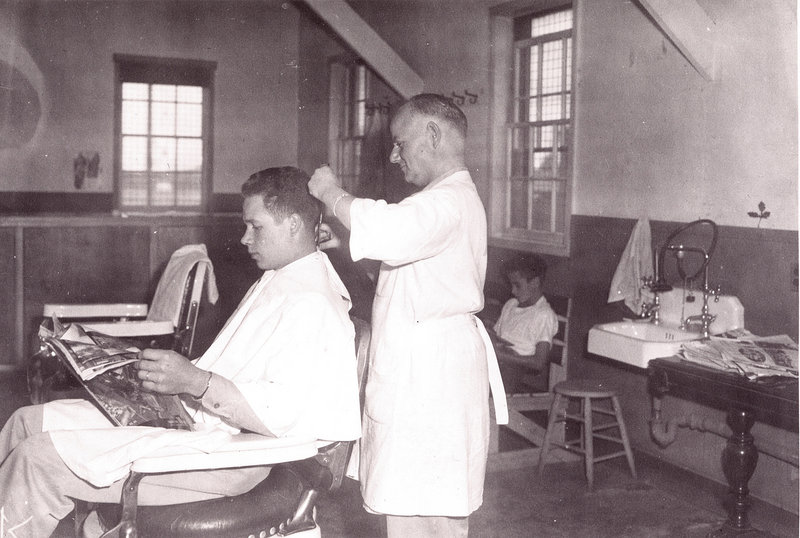 A 1945 photo of a U.S. Army barber at Camp Houlton