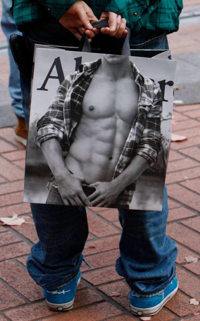 A shopper holds an Abercrombie & Fitch bag in downtown Portland, Ore.