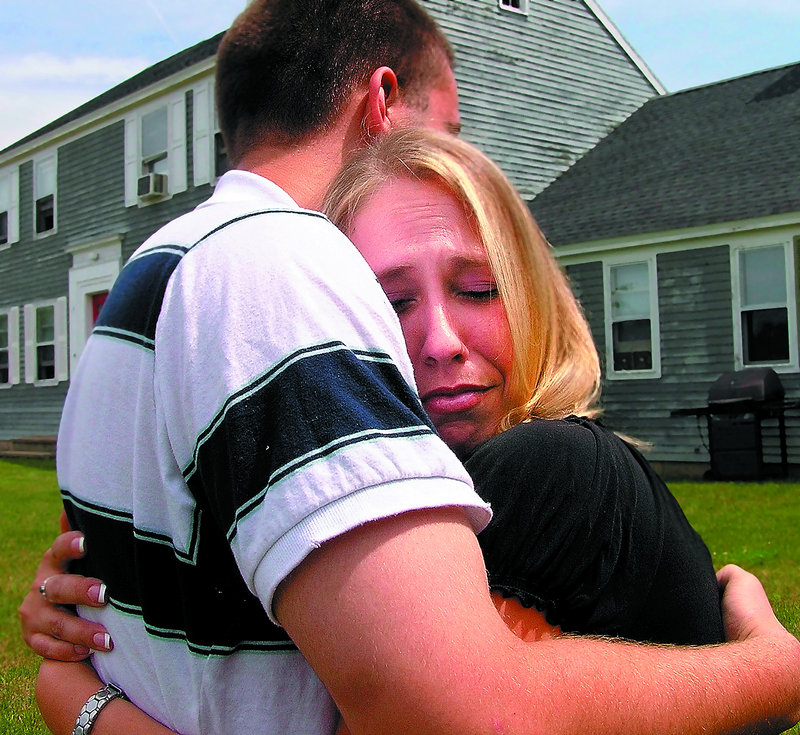 Cathy Shepherd of Manchester hugs Kendall Curit of Windham at her home Friday. Kendall and his father, Randy, rescued Shepherd after she hit a moose Sunday night on Interstate 95 in Waterville.