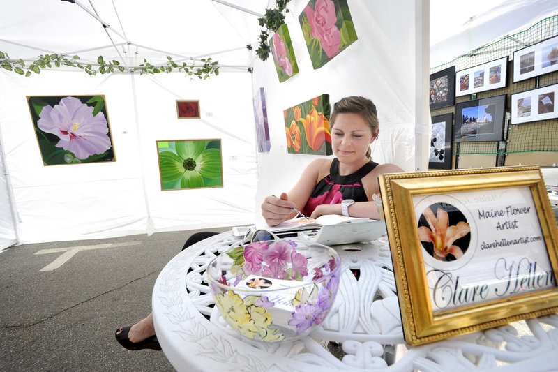 Portland artist Claire Hellen paints watercolor flowers as she displays oil paintings at the Saco Spirit Art Festival in Saco.