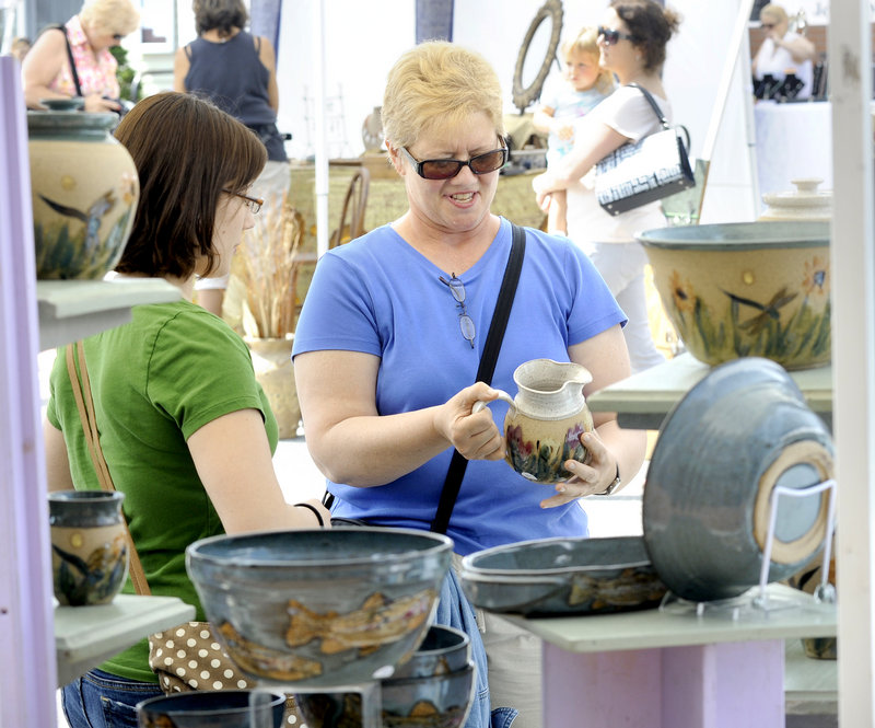 Justine Bald and her mother, Darlene Lessart, of Biddeford check out pottery.