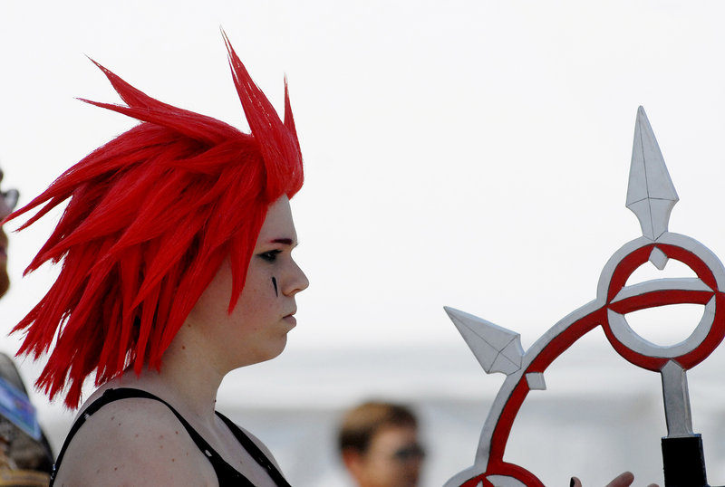 Victoria Basiner of Uxbridge, Mass., watches competitors boff (think of hand-to-hand combat with padded weapons) outside the Wyndham hotel in South Portland during the PortConMaine convention Saturday. She's dressed as the anime character Axel.