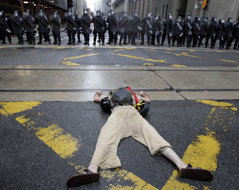 A demonstrator lies in front of a line of riot police in Toronto on Saturday as the G-20 summit got under way.