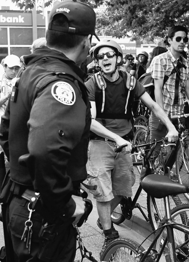 A demonstrator yells as Canadian authorities try to keep him and other bicycle riders on the sidewalk and off the street at a bike block action demonstration in Toronto on Sunday during the G-20 summit meeting. Police said they have arrested more than 560 protesters.