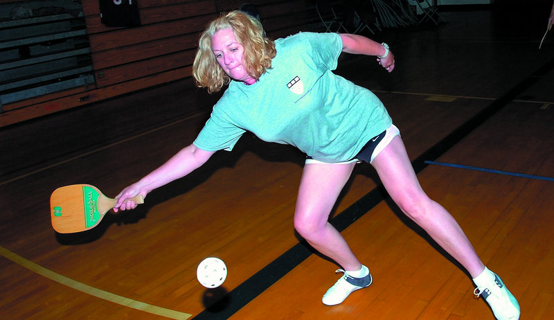 Kathy Welch returns a shot during a doubles match of pickleball at the Alfond Youth Center in Waterville. The game combines features of badminton, pingpong and tennis.