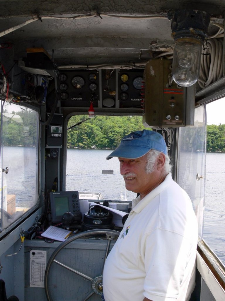 Ross Graham, lead captain of the Frye Island ferries, keeps an eye out as he heads into the dock.