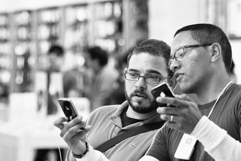 Duane Davis, left, learns about the new features of the Apple iPhone 4 while talking to an Apple employee on June 24, the first day of sales for the new phone, at the Memorial City Mall Apple Store in Houston. Apple Inc. said Monday that it sold more than 1.7 million units of the iPhone 4 in the first three days, making it the most successful product launch in the company’s history from the standpoint of sales.