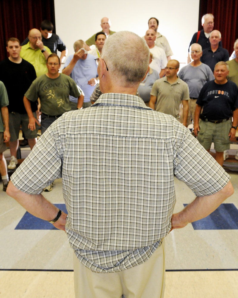 Jack Baggs, director of the Downeasters Barbershop Chorus, gives instructions during the group’s final rehearsal before it competes at the International Barbershop Convention in Philadelphia.