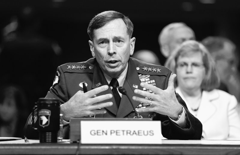 Gen. David Petraeus testifies Tuesday on Capitol Hill before the Senate Armed Services Committee. At right is his wife, Holly Petraeus.