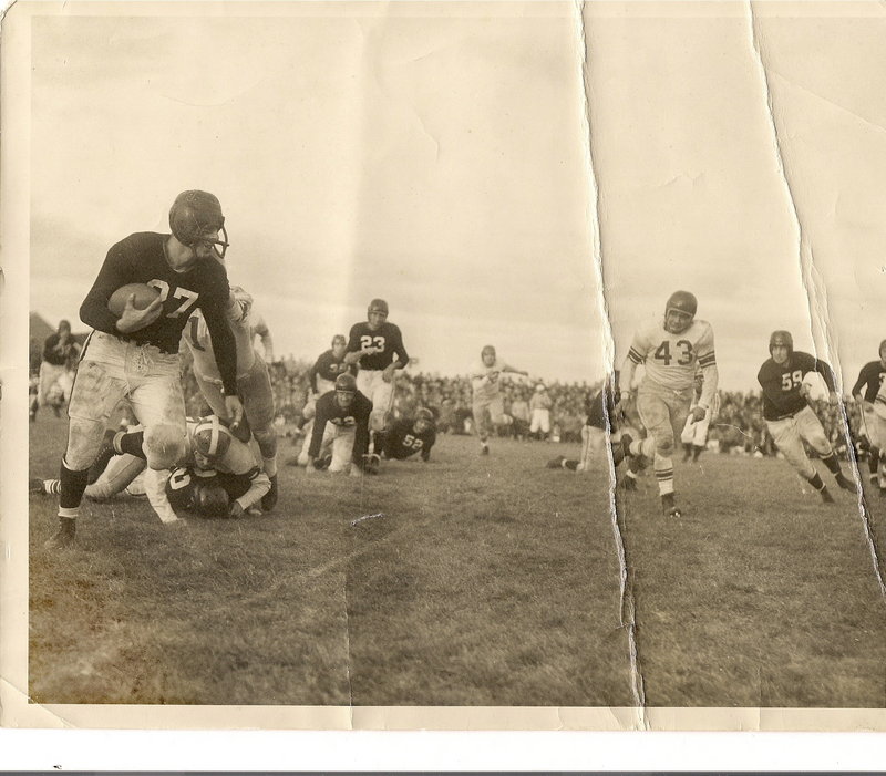 Arthur Bishop runs with the football during a game between Bowdoin and Colby colleges in 1951. He wore a guard to protect his broken nose.