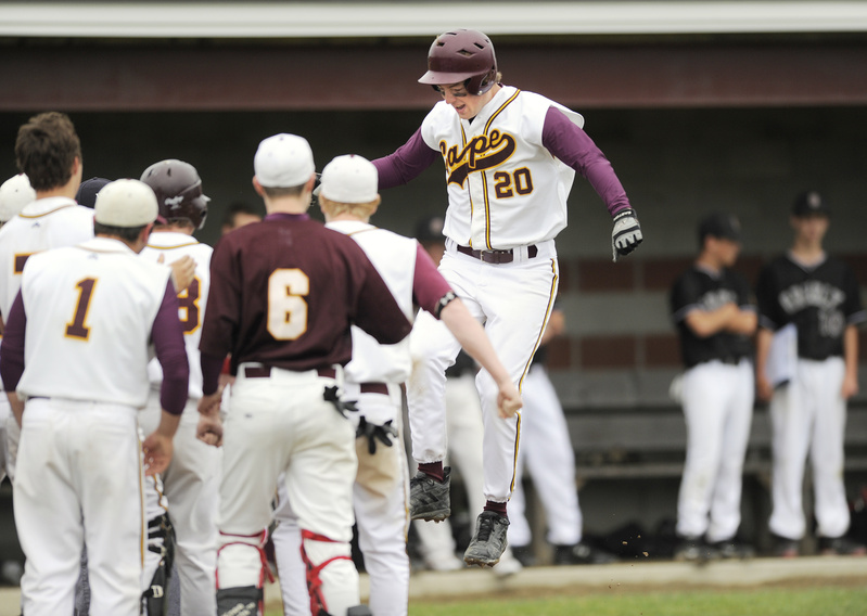 Will Pierce of Cape Elizabeth leaps on the plate and is greeted by teammates Saturday after a two-run homer in the third inning of a 4-3 victory over Greely in a Western Class B semifinal.
