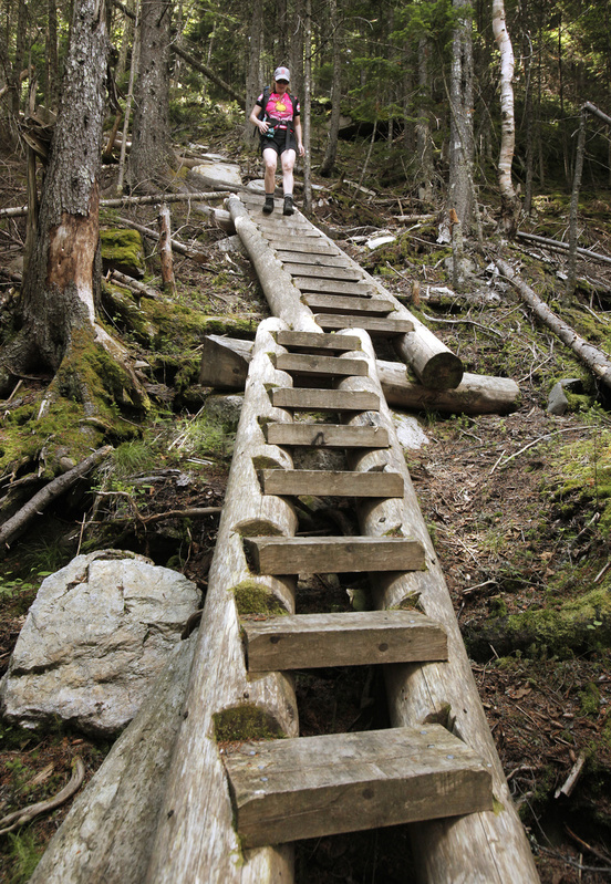 Reporter Deirdre Fleming walks down ladder steps on the part of the Grafton Loop Trail descending from Bald Mountain in Newry.