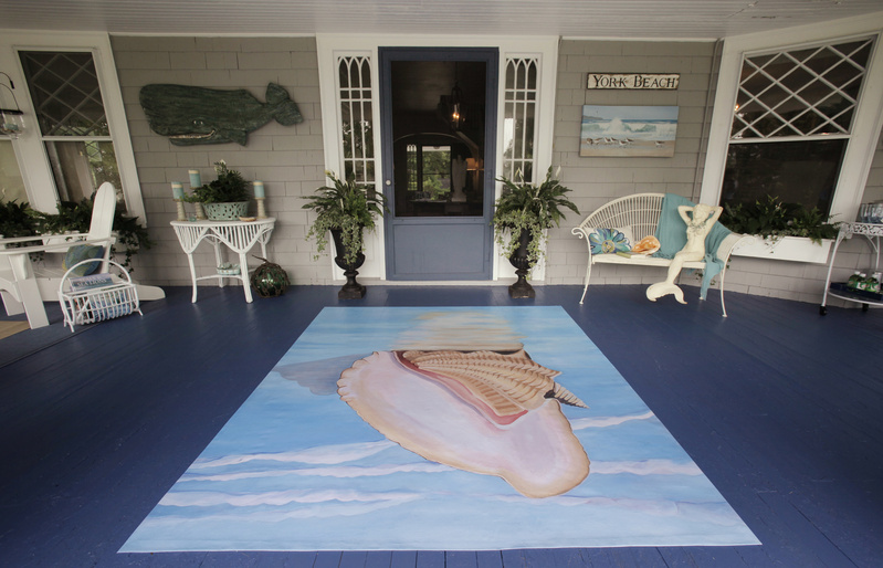 York designer Georgie McGowan painted the back porch an ocean blue and used an oilcloth with a seascape on it as a floor covering. Oilcloths were used in the early 1900s on porches or verandas.