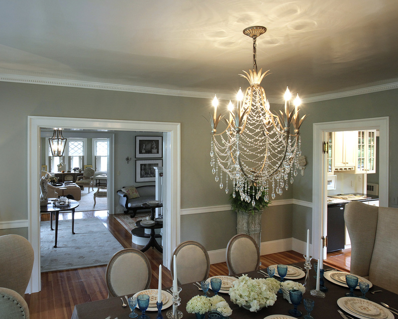 A chandelier provides a focal point in a dining room designed by Nicole Yee at Twin Cottage.