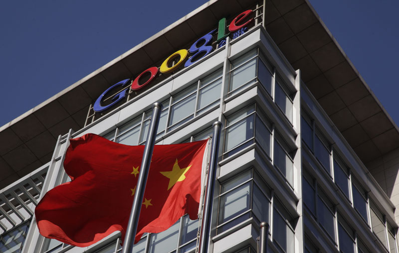 In this file photo, a Chinese flag flutters outside Google's China headquarters in Beijing. Google on Friday, July 9, 2010 said Beijing has renewed the license it needs to continue operating a website in China, securing the search giant's foothold in the world's biggest Internet market despite tensions over censorship.