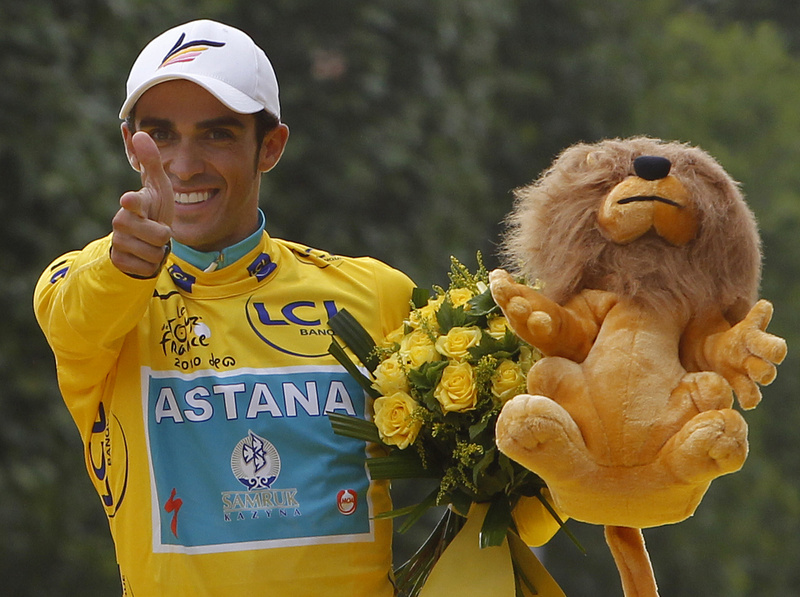 Three-time Tour de France winner Alberto Contador of Spain celebrates on the podium after the 20th and last stage of the Tour de France cycling race today in Paris.
