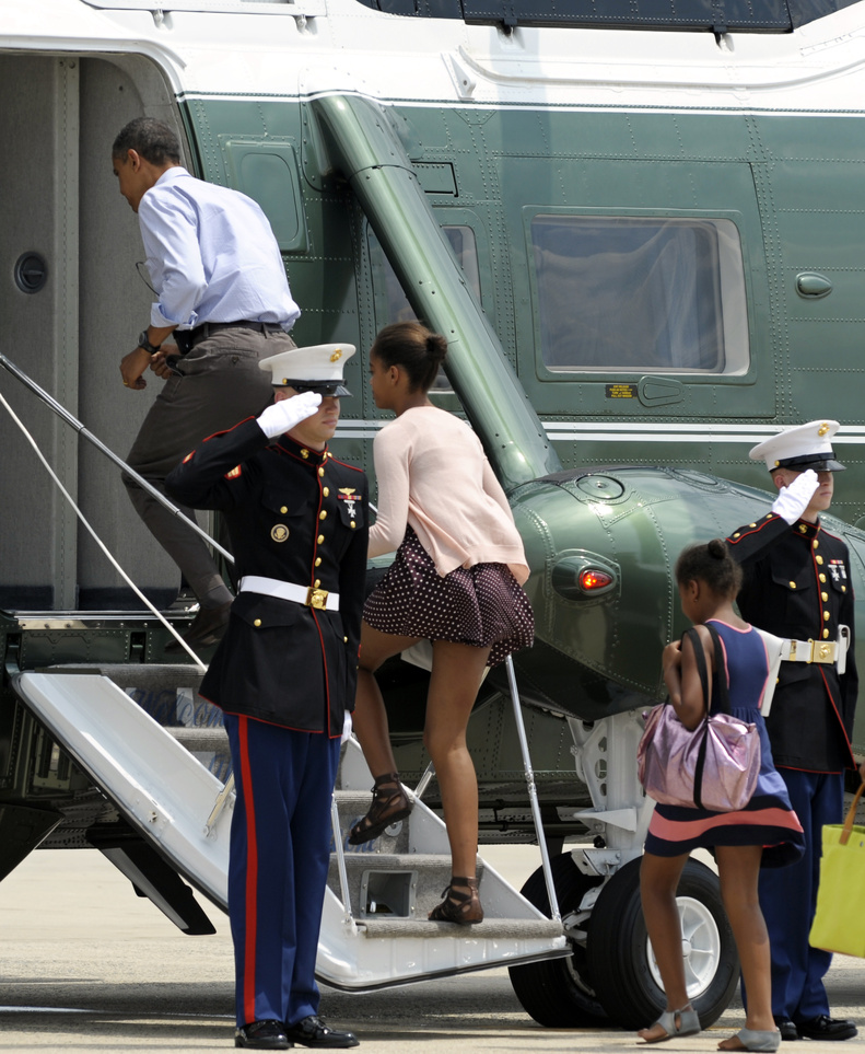 President Barack Obama, followed by his daughters Malia, center, and Sasha, right, board Marine One at Andrews Air Force Base today on their return to the White House after a weekend vacation Maine.