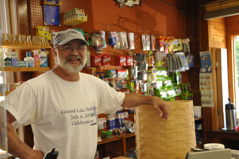 Kurt Cressey with a hand-woven pack basket at Pine Tree Store in Grand Lake Stream. He and his wife, Kathy, have run the store since April 1995.