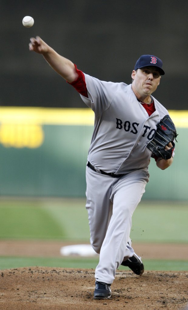 John Lackey delivers a pitch against the Seattle Mariners on Thursday in Seattle. Lackey took a no-hitter into the eighth inning for the Boston Red Sox.
