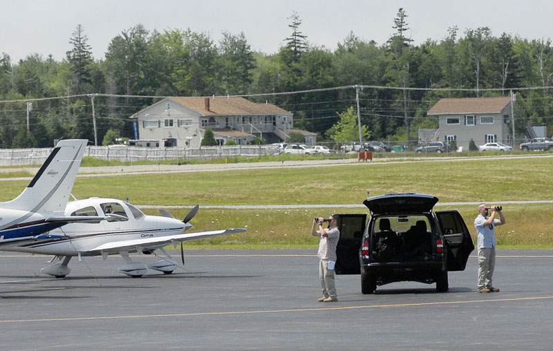 Security personnel look over the scene at airport in Trenton today before the president's arrival.