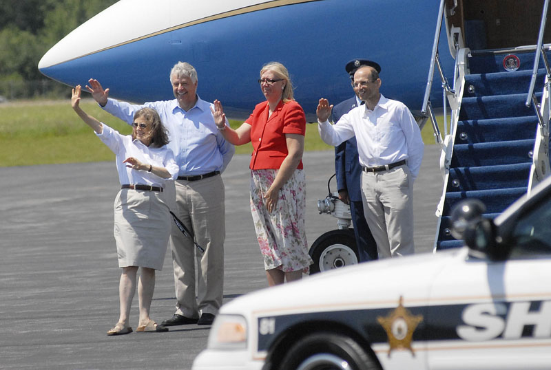 From left: Chair of the Bar Harbor Town Council, Ruth Eveland, U.S. Rep. Mike Michaud, Karen Baldacci and Gov. John Baldacci wave as the president leaves the airport on his way to Mount Desert Island.