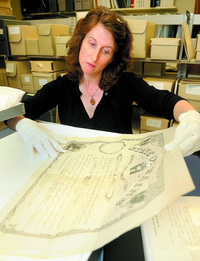 Kate McBrien, curator of historic collections, shows John Dana's discharge from the Union Army at the Maine State Museum in Augusta. The museum recently purchased a collection of Dana's Civil War letters and other artifacts.
