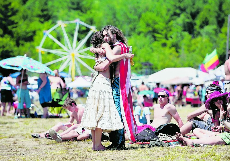 Noel Sanborn of West Hartford, Conn., gets a hug from Mark Nastasi of Burlington, Vt., who was giving out hugs and free massages during the festival.