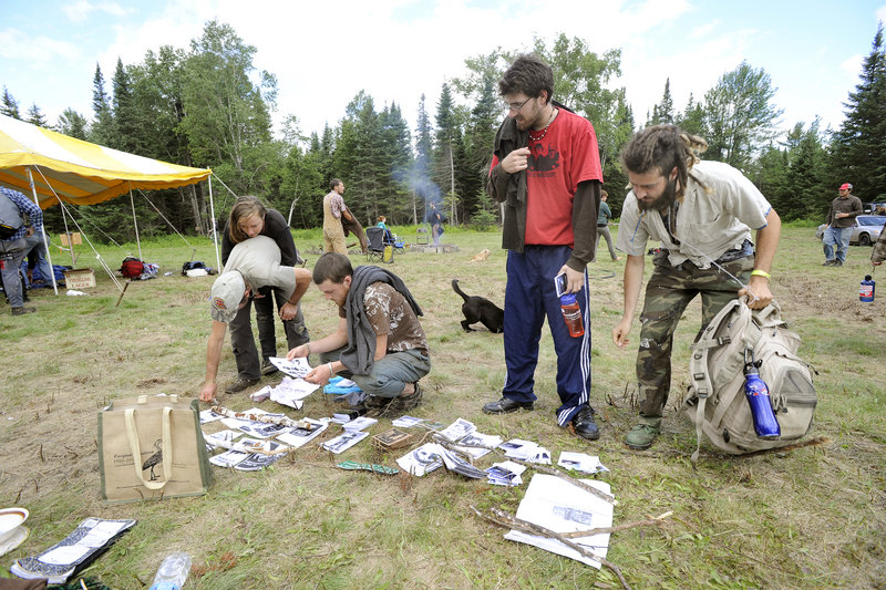 Participants check out booklets after their morning meeting at the North Woods Round River Rendezvous on Saturday.