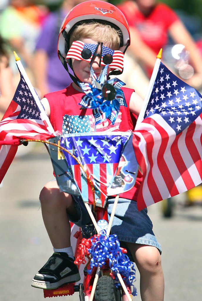 Joey Martellucci, 5, of North Andover, Mass., rides his bike during the Independence Day parade in Ocean Park on Monday. Joey entered his bike in the Decorated Bicycle Contest and rode with the other contest participants.