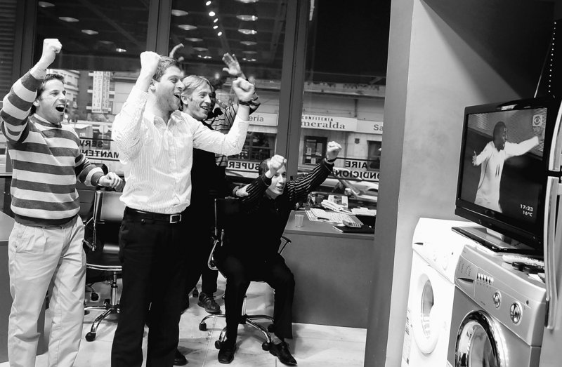 The Associated Press Sales workers at an appliance store in Montevideo, Uruguay, celebrate a goal by their nation’s team during a World Cup match against South Africa on June 16.