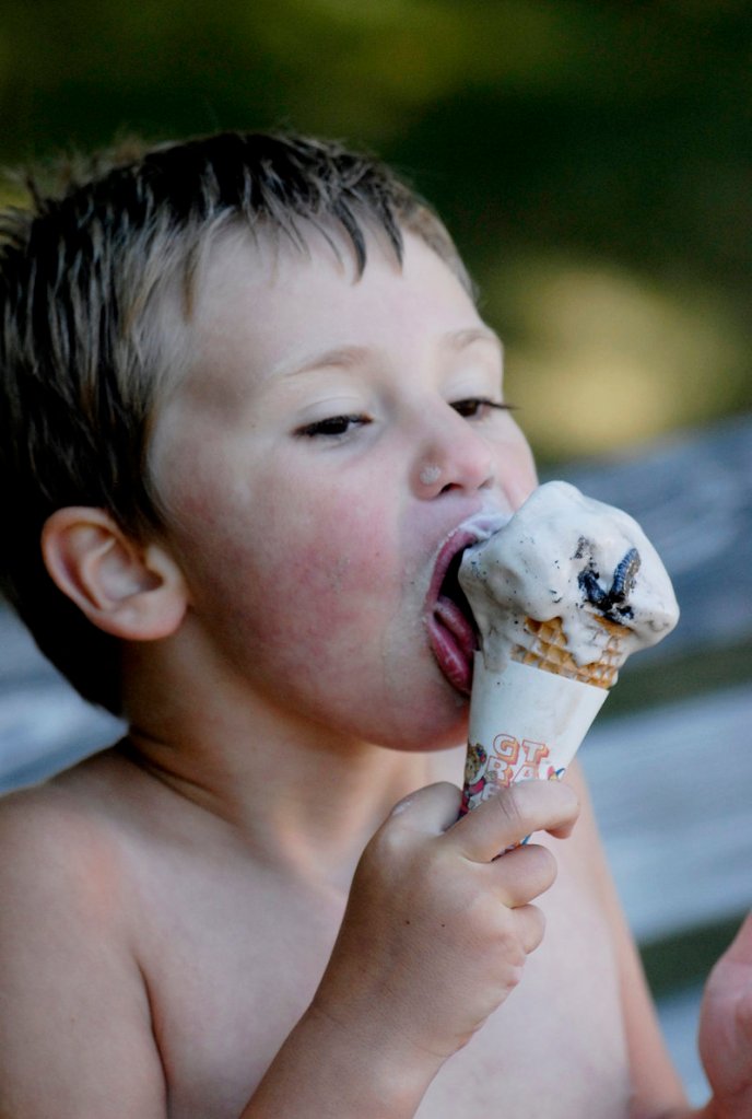 Ash Moore, 4, of Gray enjoys an ice cream cone at Garside's in Saco. Maine ice cream sellers report brisk sales this summer of everything from soft serve to gelato.
