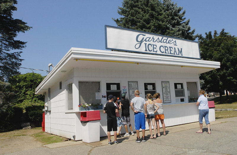 Customers at the window of an ice cream stand – in this case, Garside's in Saco – are a summer tradition. What's new are the flavors available at Maine shops, including salt caramel, Thai chili and coconut.