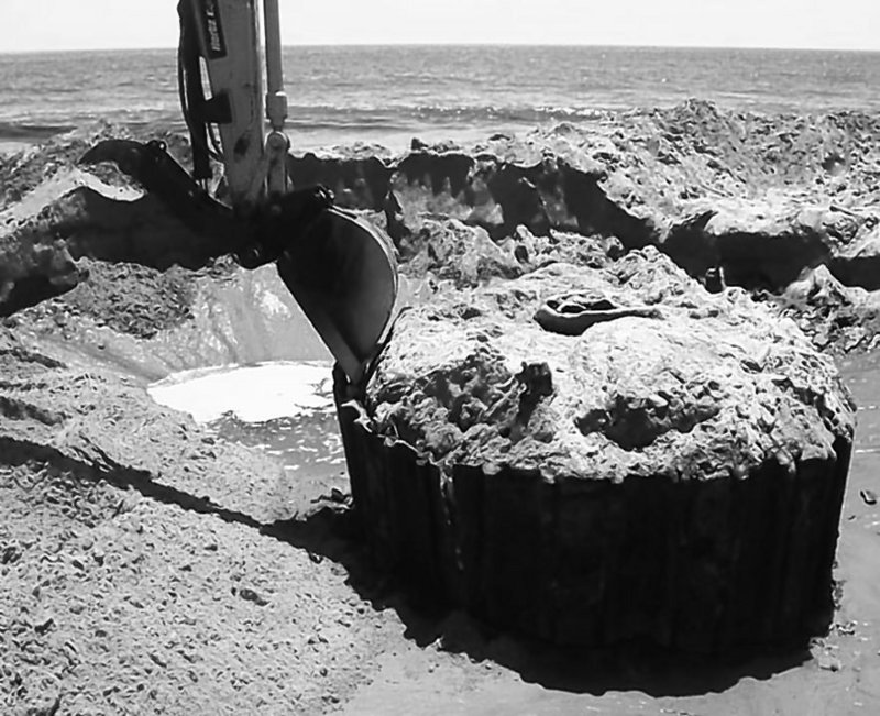 A near-shore wellhead is excavated off California so it can be recapped. There is, however, no program for recapping or inspecting abandoned wells in federal waters.