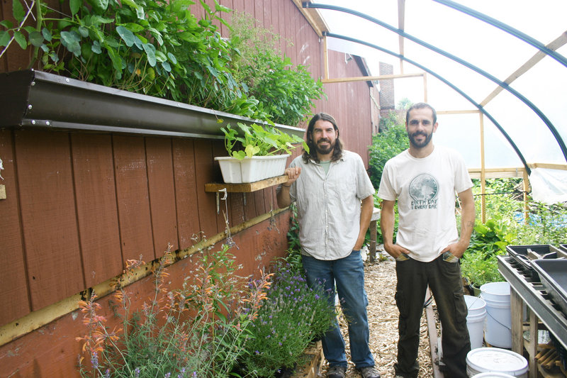 David Homa and Eli Cayer stand in the permaculture garden behind the Urban Farm Fermentory in Portland.