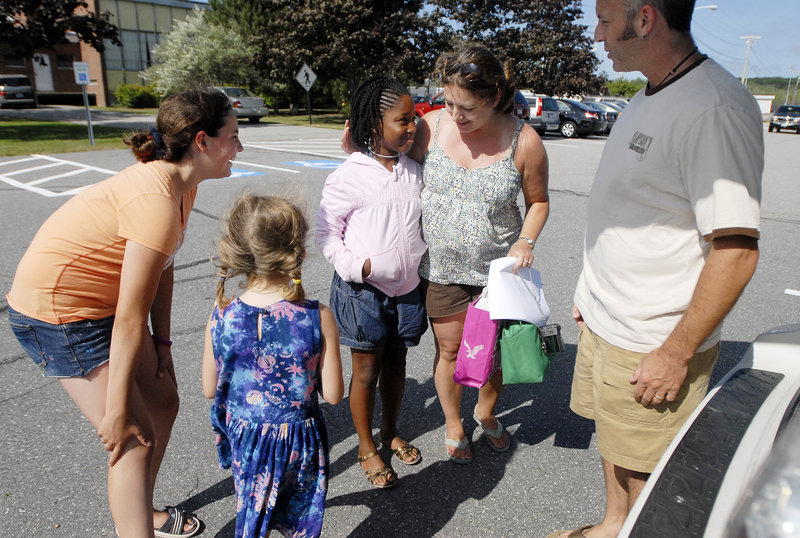 The Grosso family of Westbrook, including from left, Olivia, 12, Chloe, 6, Wyndee and Peter, greet Imani Marcelo of Queens, center, as she arrives to spend her second summer with them. Most Fresh Air Fund kids stay with their host families for two weeks, but many end up extending their vacations, organizers say. Others, like Imani, make repeat visits.