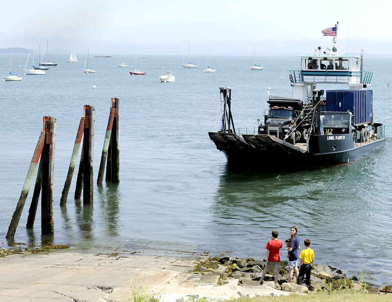 Children watch as a commercial vehicle ferry departs Thursday from the East End Boat Launch in Portland. The ferry services most of the islands in Casco Bay.