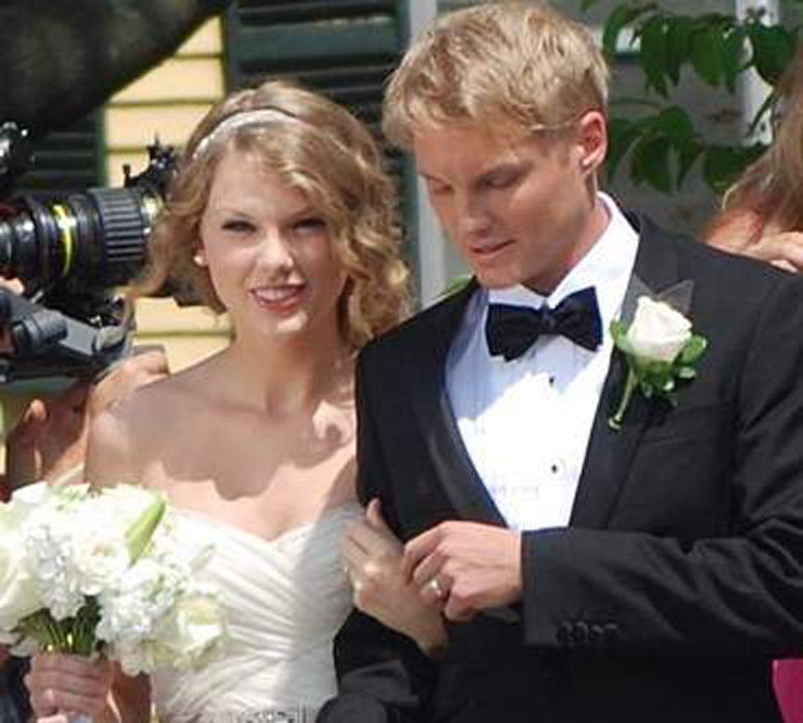 Taylor Swift and an unidentified man shoot a wedding scene for a music video outside Christ Church in Kennebunk on Thursday.