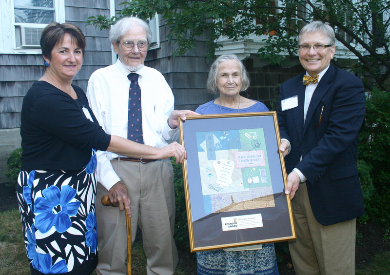 Jeannine Lepitre, CSI’s CEO, the Rev. Robert Howes, his wife, Christine Howes, and Dr. Vernon Moore, president of the board. They’re all holding the Howes' award featuring original artwork by Sonya Tuttle.