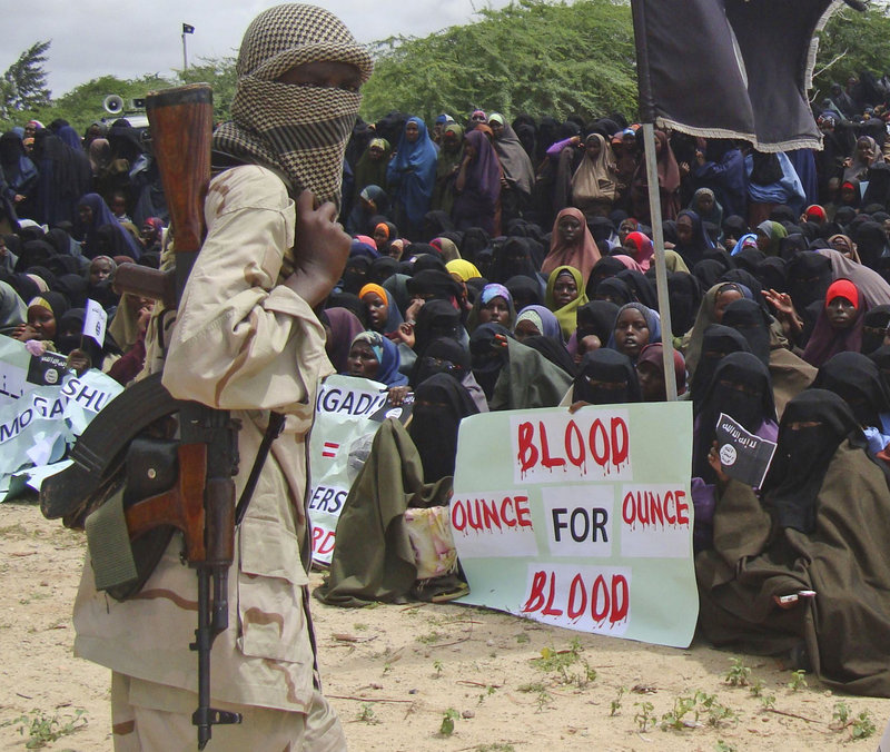 Supporters of the militant al-Shabab group shout slogans during a demonstration this week in Mogadishu, Somalia. The group is recruiting fighters among Somali communities.