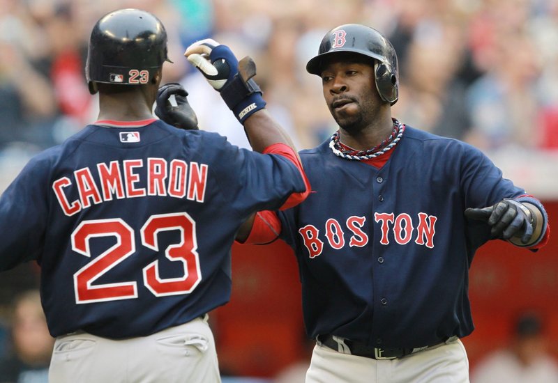 Mike Cameron, left, and Bill Hall celebrate Hall’s two-run homer Friday during Boston’s 14-3 victory against Toronto.