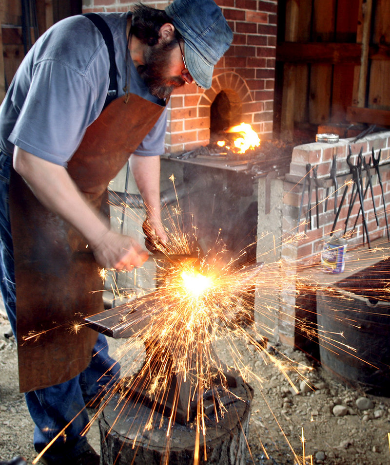 Blacksmith Tim Greene of Parsonsfield hammers out a link for a horse chain during a demo at the fair.
