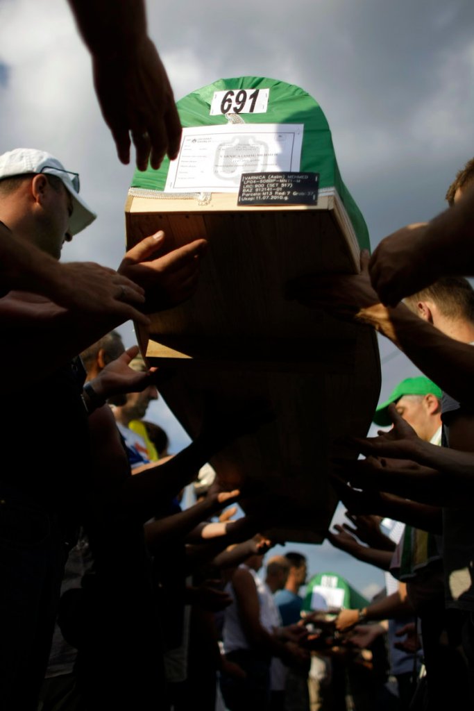 Men carry coffins of victims of the 1995 Srebrenica massacre in Potocari, Bosnia-Herzegovina, on Saturday. Some 775 bodies excavated from mass graves will be buried today.