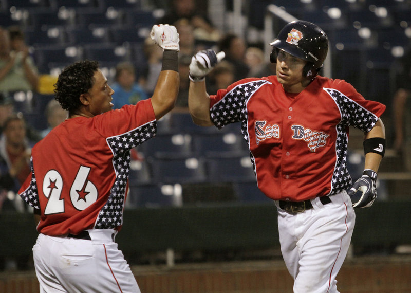 Nate Spears of the Portland Sea Dogs, right, is met at the plate by teammate Luis Segovia after hitting a two-run homer in the third inning of a 7-6 loss Saturday night to the New Britain Rock Cats. It was Spears' 10th homer of the season.