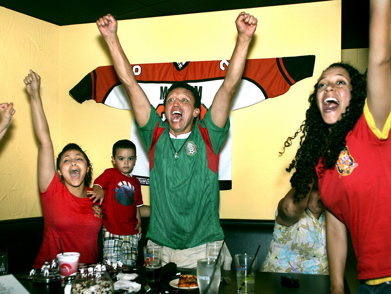 Fans around the world celebrated Spain's victory, including Byron Saavedra of Portland, who reacts to Iniesta's goal. Sharing Saavedra's enthusiasm are his daughter Nicole, left, his grandson Korben, 2, and his daughter Stefanie. The family watched the final match at G&R DiMillo's Bayside Restaurant in Portland.