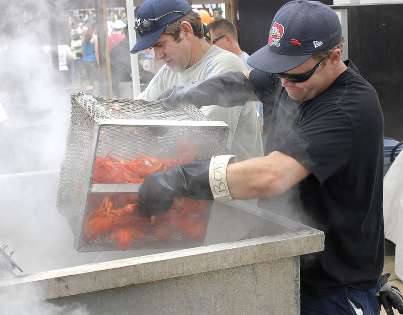 Volunteers get boiled lobsters ready for shore dinners at the 2008 festival.