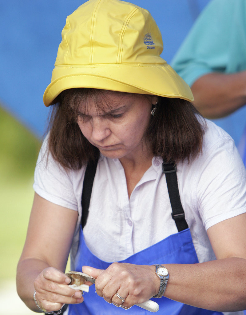 Reigning champion Beattie Quintal of Waldoboro shucks clams at the 2007 Yarmouth Clam Festival. Quintal will defend her crown in the professional division of the shucking contest on Saturday.