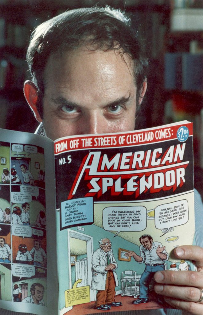 Comic book writer Harvey Pekar poses with a copy of his “American Splendor.” Pekar was found dead in his Ohio home early Monday.